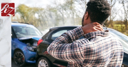 African American man holding back of neck after car accident